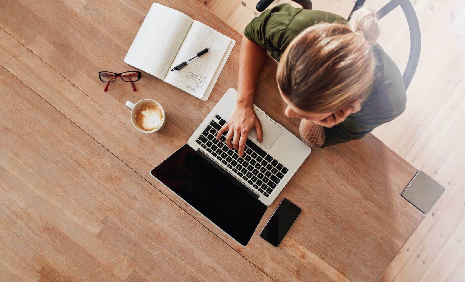 Woman creating content at a laptop.