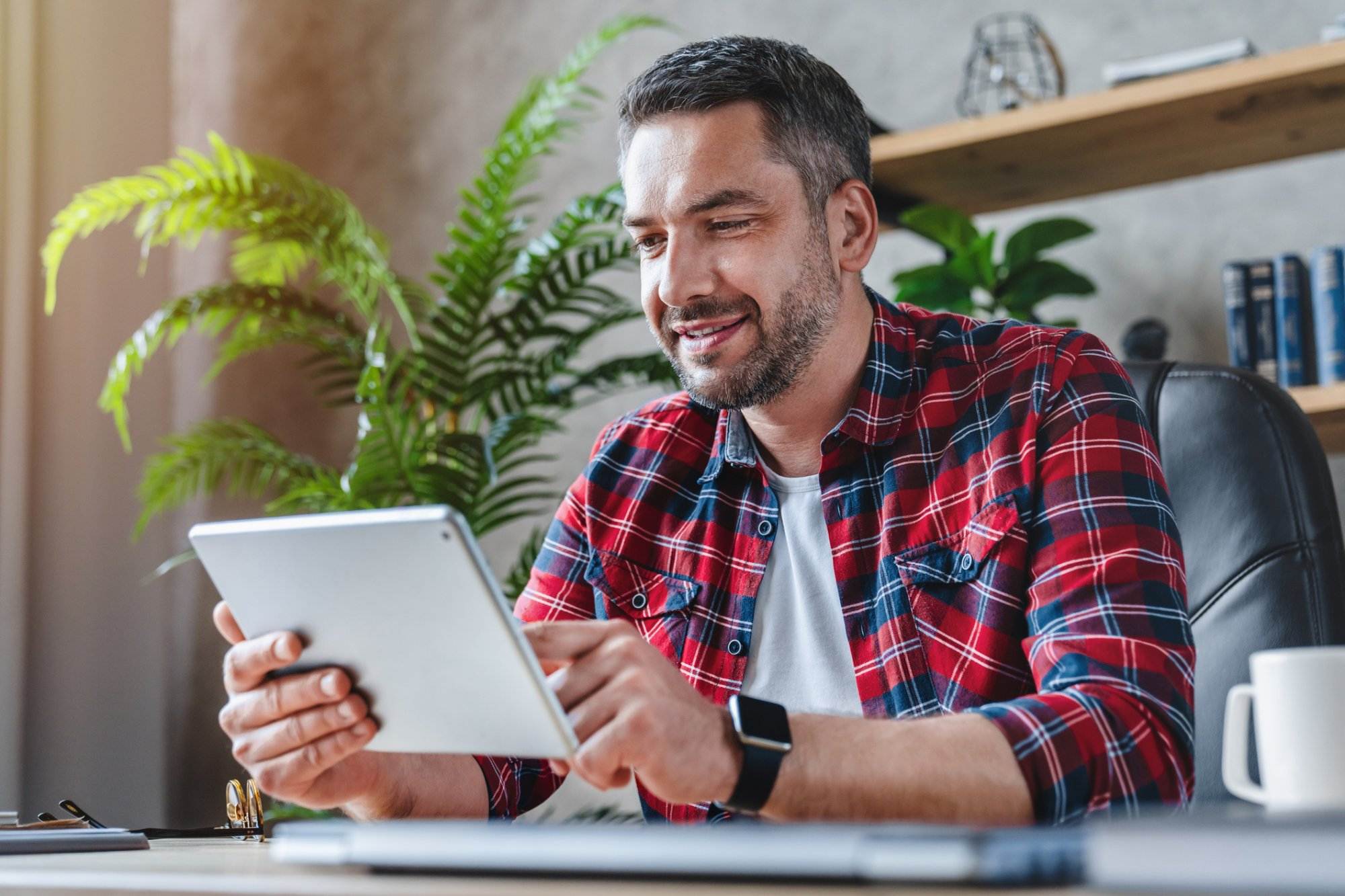 Man on tablet exploring different apps for Digital Marketing