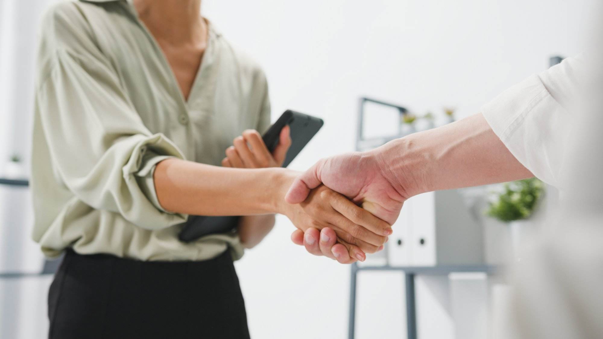 Person shaking hand with customer