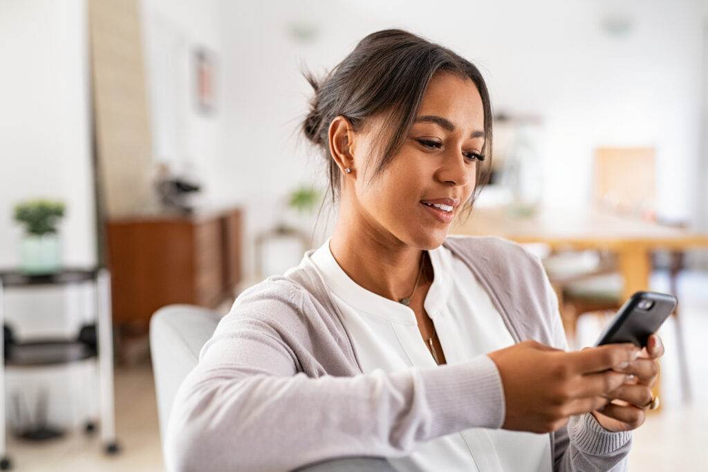 Young professional creating a social media strategy on her phone.